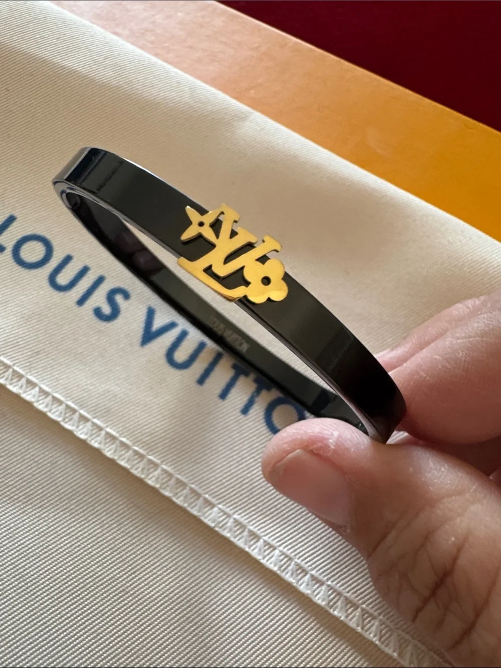 Louis Vuitton Black Bangle with Gold LV Motif